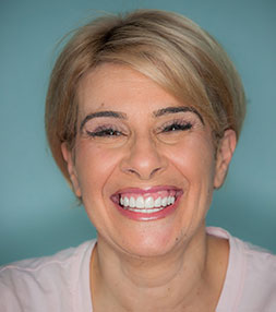 A happy smiling lady after a dental procedure at Bay Premier Dentistry
